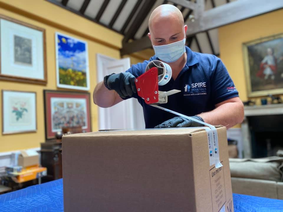 A member of the Spire Removals team, Hampshire, doing specialist packing to ensure possessions are safe from any damage.