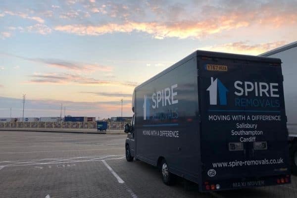 Spire Removals, a removals and storage company based in Wiltshire, can help with European moves. Here is a Spire van with a man inside.