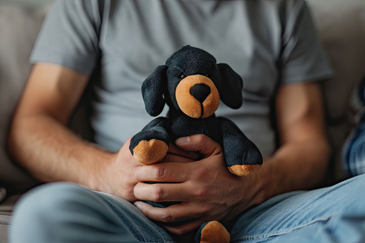 Man with cuddly toys