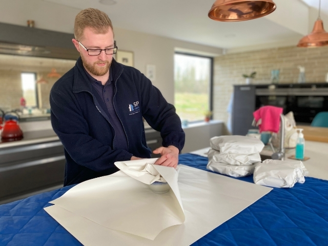 Packing services demonstrated by a member of staff from Spire Removals, Salisbury, Wiltshire.