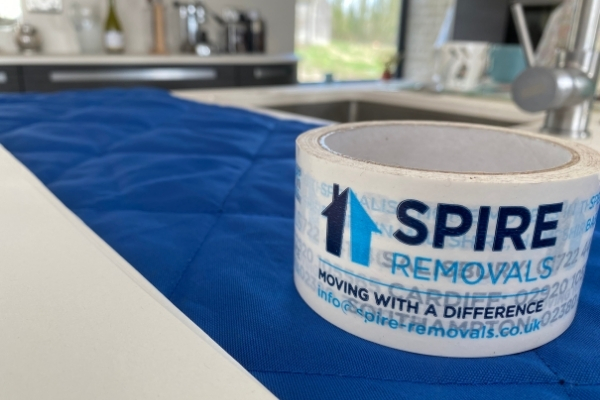 Spire Removals tape is displayed on top of a kitchen counter during a house move, Wiltshire.